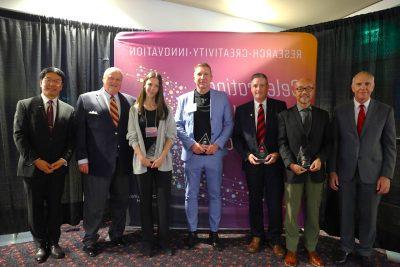 winners posing with university leaders